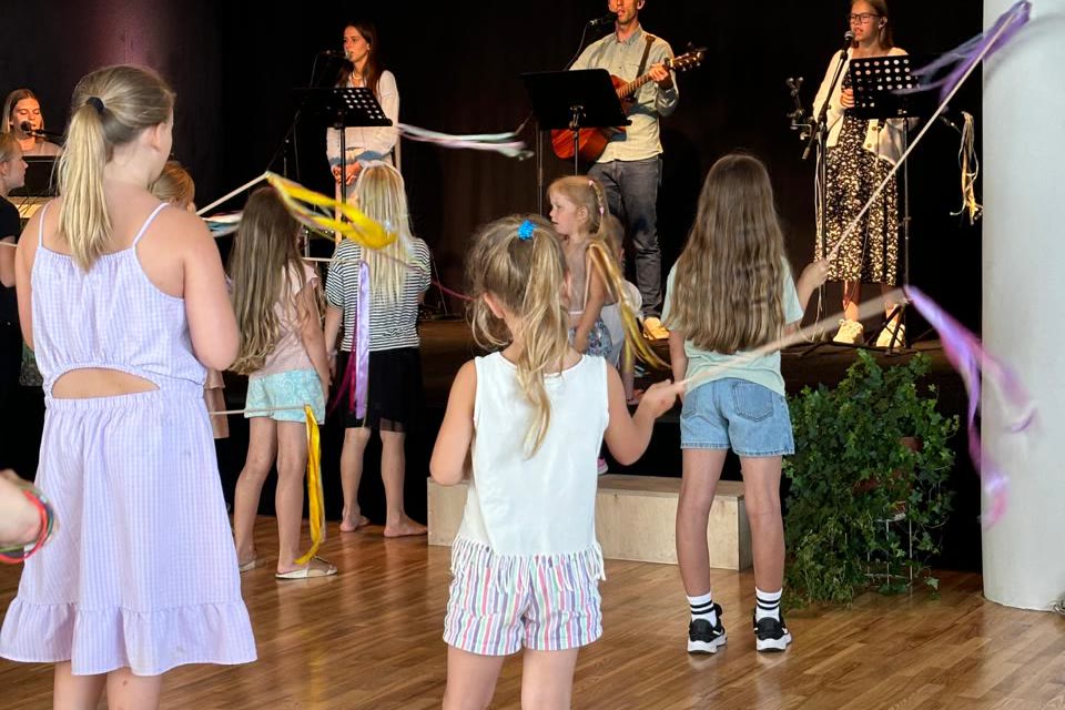 Children dancing during worship in Kuldīga